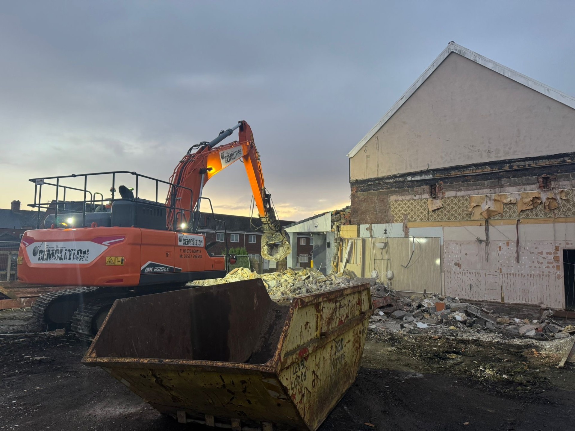 Orange demolition excavator with hydraulic shears